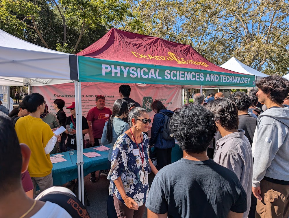 students talking outside Physical Sciences tent